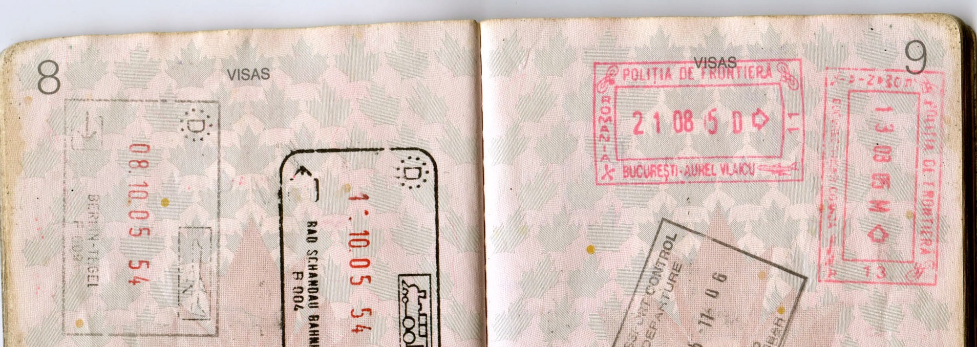 Authentic German and Romanian border stamps across two open passport pages, cropped to exclude personal details